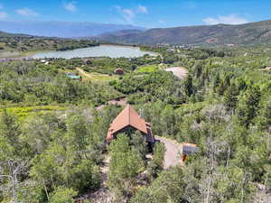 Drone / aerial view featuring a water and mountain view