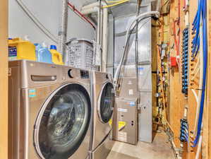 Clothes washing area featuring washer and clothes dryer