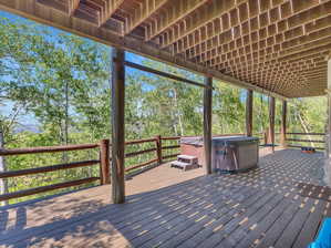 Wooden terrace featuring a hot tub