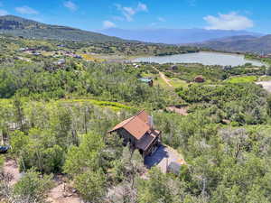 Drone / aerial view featuring a water and mountain view