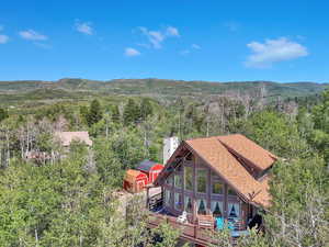 Back of property with a deck with mountain view