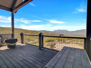 Wooden deck featuring a mountain view