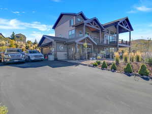 View of front of home with a garage and covered porch