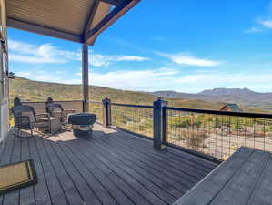 Wooden deck featuring a mountain view