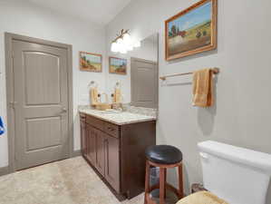 Bathroom featuring tile patterned floors, toilet, and vanity