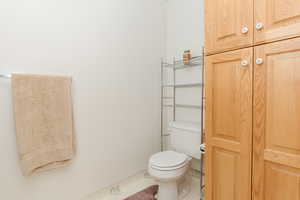 Bathroom featuring tile patterned flooring and toilet