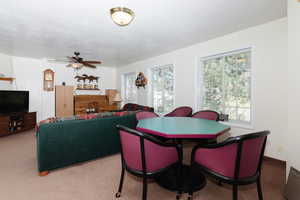 Dining room featuring light colored carpet and ceiling fan