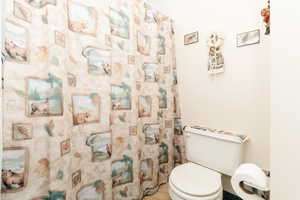 Bathroom featuring tile patterned floors and toilet