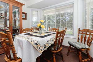 Dining room with plenty of natural light and carpet floors