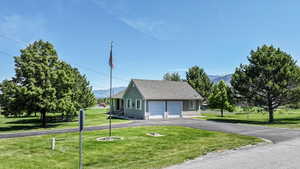 View of front of house with a garage and a front yard