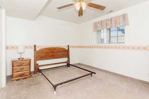 Carpeted bedroom with ceiling fan