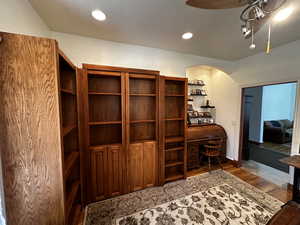 Office with hardwood / wood-style floors and ceiling fan