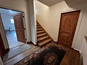 Stairway featuring hardwood / wood-style flooring