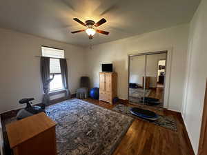 Living area featuring hardwood / wood-style floors and ceiling fan