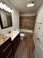 Bathroom featuring vanity, wood-type flooring, and toilet