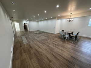 Dining area featuring dark wood-type flooring and a notable chandelier