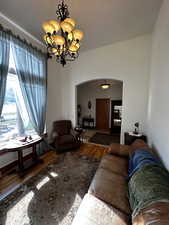 Living room featuring hardwood / wood-style floors and an inviting chandelier