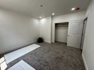 Unfurnished bedroom featuring carpet and a closet