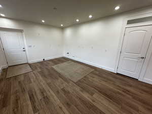 Spare room with dark wood-type flooring