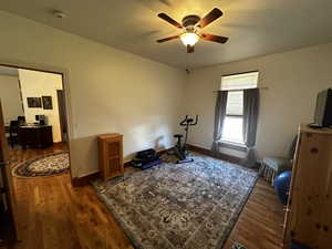 Interior space with ceiling fan and dark hardwood / wood-style flooring