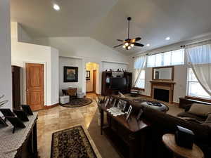 Tiled living room featuring lofted ceiling and ceiling fan