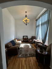 Living room featuring wood-type flooring and a chandelier