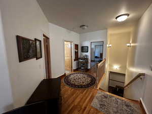 Hallway featuring wood-type flooring