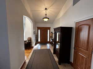 Entryway featuring vaulted ceiling and light hardwood / wood-style flooring