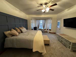 Bedroom featuring ceiling fan, light colored carpet, and multiple windows