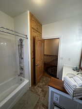 Bathroom featuring vanity and tiled shower / bath