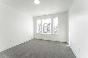 Unfurnished room with carpet and a textured ceiling