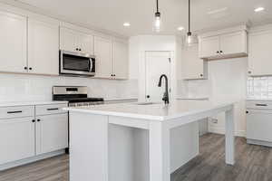 Kitchen with sink, stainless steel appliances, and an island with sink