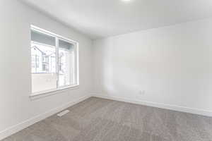 Spare room with carpet flooring and a textured ceiling