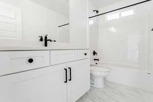 Full bathroom featuring vanity,  shower combination, and toilet