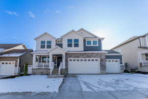 View of front of property featuring a porch and a garage