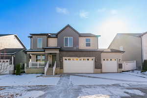 View of front of house with a garage and covered porch