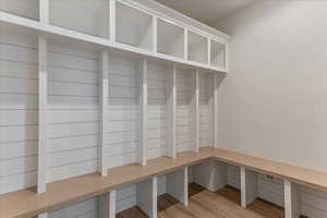 Mudroom with light hardwood / wood-style floors