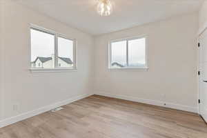 Spare room featuring light wood-type flooring