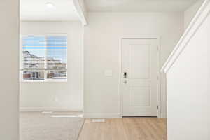 Foyer entrance with light hardwood / wood-style floors