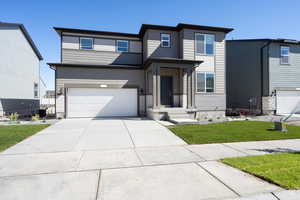 View of front of house featuring cooling unit, a front lawn, and a garage