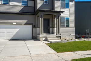 Doorway to property with a garage