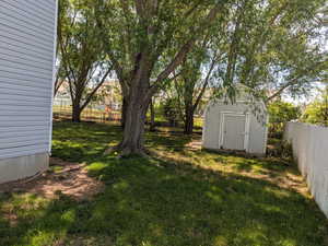 View of yard featuring a storage unit