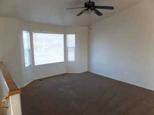 Unfurnished room featuring carpet flooring, a healthy amount of sunlight, and ceiling fan