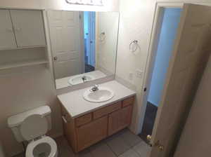 Bathroom with vanity, tile patterned flooring, and toilet