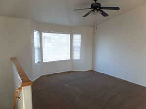 Carpeted empty room with ceiling fan