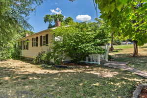 View of side of property with a lawn