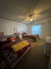 Bedroom featuring a textured ceiling, carpet, and ceiling fan