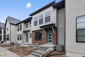 View of front of property with cooling unit