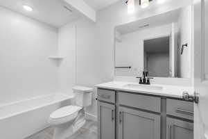 Full bathroom with tile patterned flooring,  shower combination, toilet, and vanity