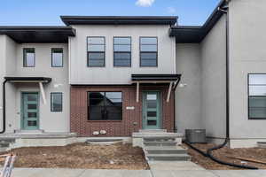 View of front of home featuring central AC